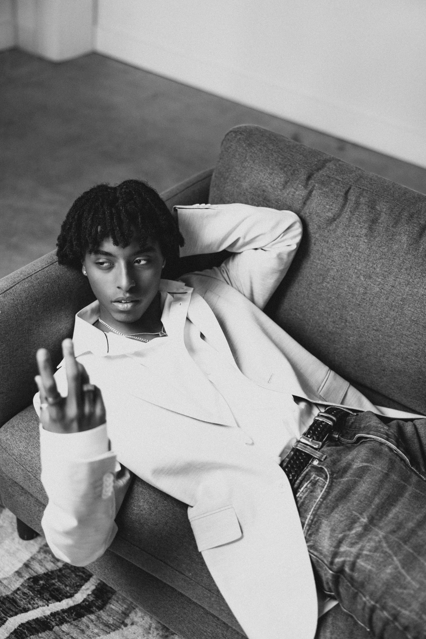 Mekonnen Knife laying back on a couch with a neutral expression